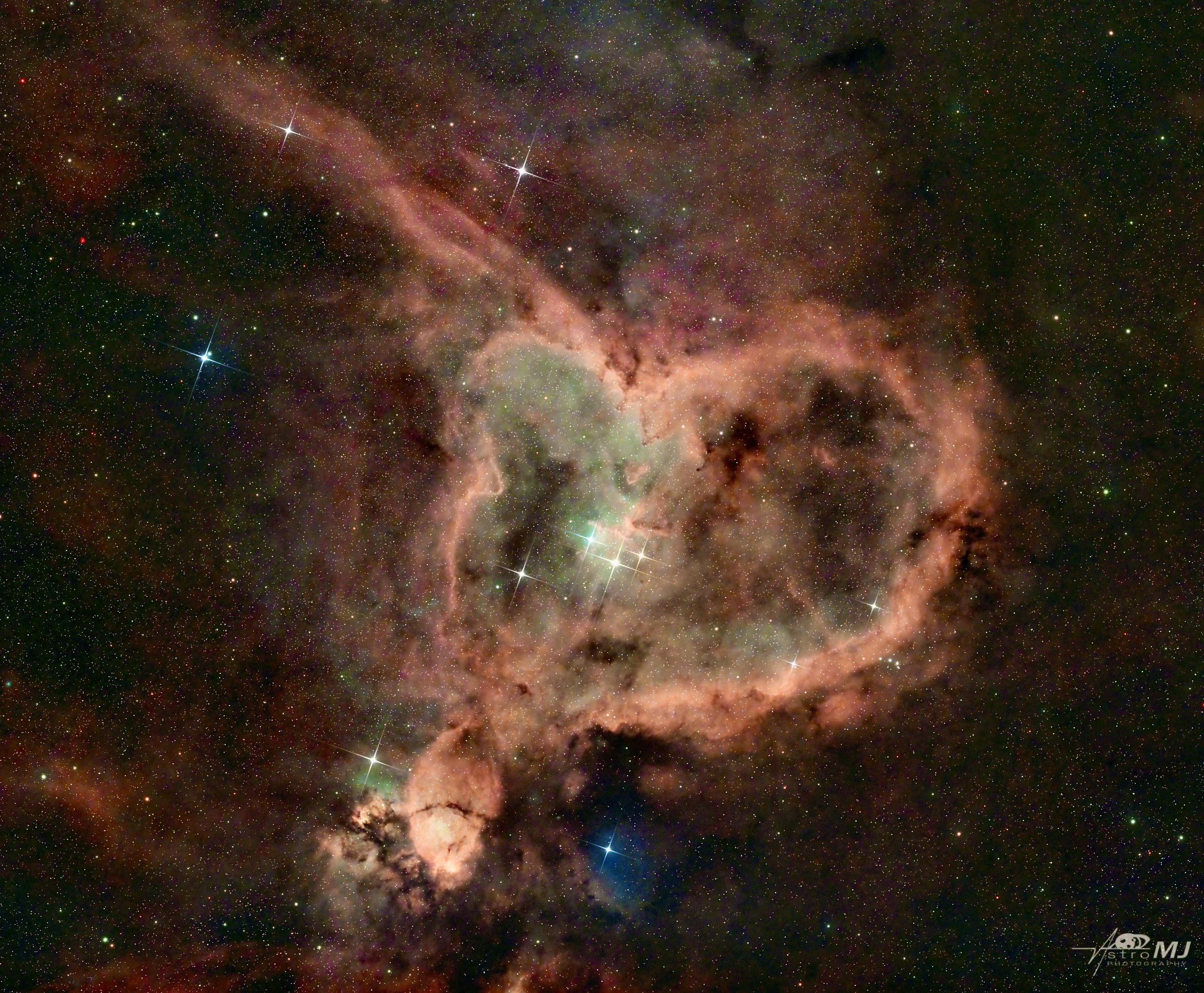 The Heart Nebula, a rose-pink emission nebula with a glittering open cluster at its center