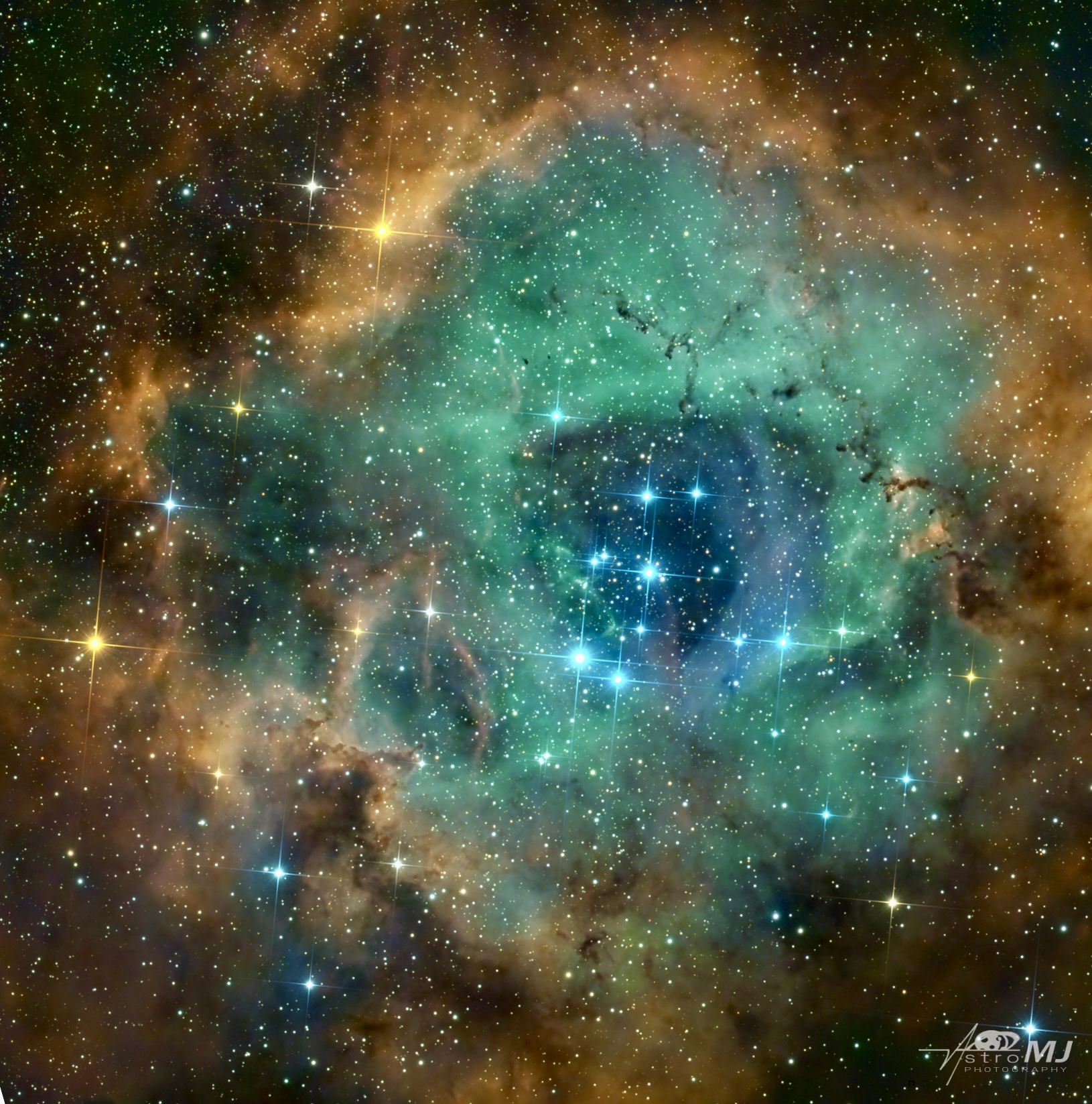 The Rosette Nebula, a teal and gold ring with a brilliant open cluster eye at center